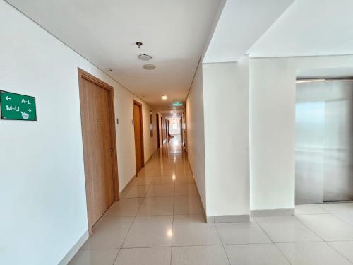 an empty corridor in a building with a hallway at Apartemen B Residence By LiviRooms BSD CITY in Cilandak