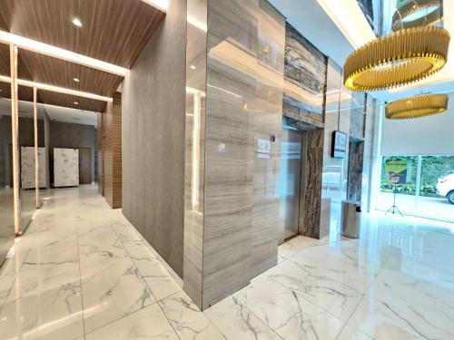 an office lobby with marble flooring and a wall of glass at Apartemen B Residence By LiviRooms BSD CITY in Cilandak