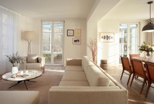 a living room with a couch and a table at Le Grand Pavillon Chantilly in Chantilly
