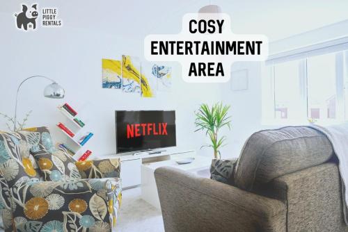 a living room with a couch and a tv at Central 2 Bedroom Flat with 2 Parking Spaces, Quiet and Modern Stay in Peterborough