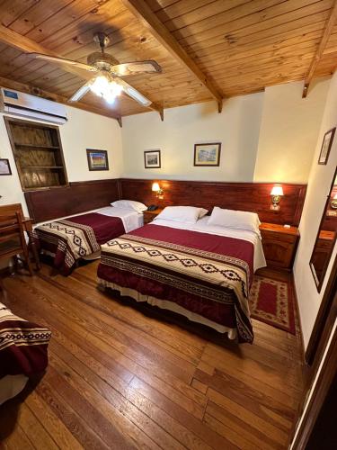 a bedroom with two beds and a ceiling at Hosteria Sirenuse in Mar del Plata