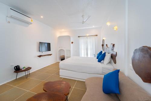 a hotel room with a bed and a couch at Conch Resort Luxury Private Pool Suites in Puducherry