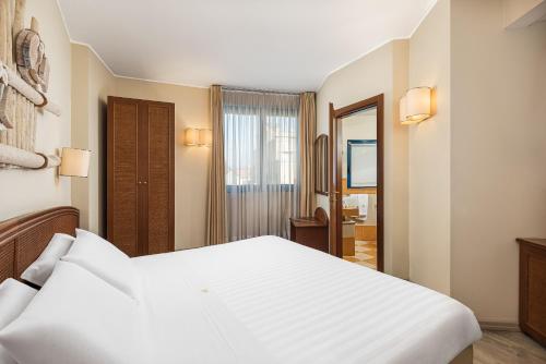 Postel nebo postele na pokoji v ubytování Welcome Hotel