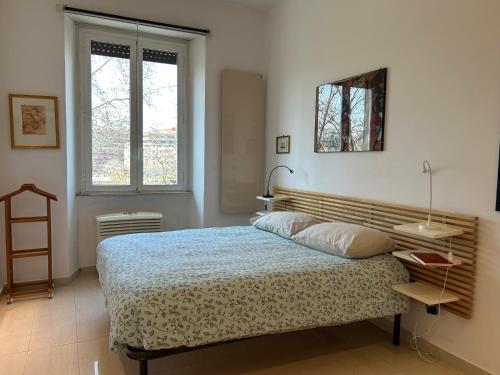 a bedroom with a large bed and a window at La Riva Sinistra in Rome