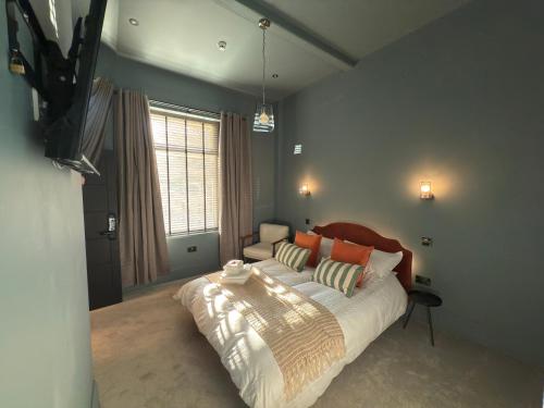 a bedroom with a bed and a television in it at Akroyd House - The Mackintosh Room in Halifax