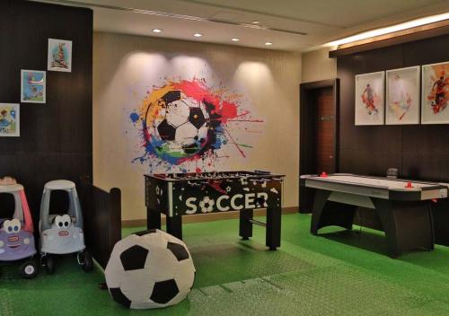 a room with a table and a soccer ball on the floor at Jabal Omar Hyatt Regency Makkah in Makkah