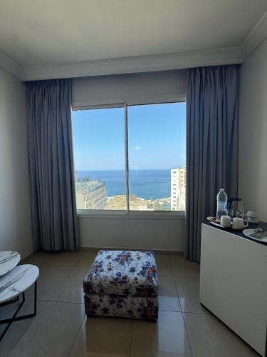 a room with a large window with a view of the ocean at Ny Suites in Beirut
