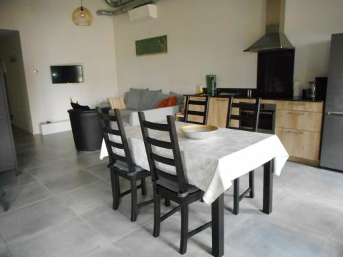a kitchen and dining room with a table and chairs at De Hoog Velden 14 in Pelt