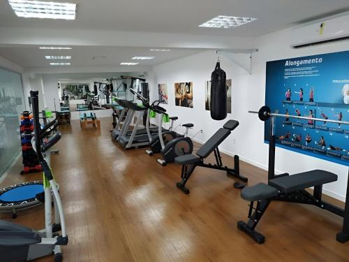 a gym with several treadmills and weights at Beto Carrero, pé na areia, piscina aquecida, Bali in Piçarras