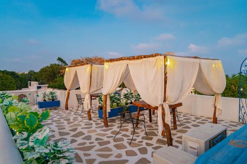 a row of umbrellas and chairs on a patio at Conch Resort Luxury Private Pool Suites in Puducherry