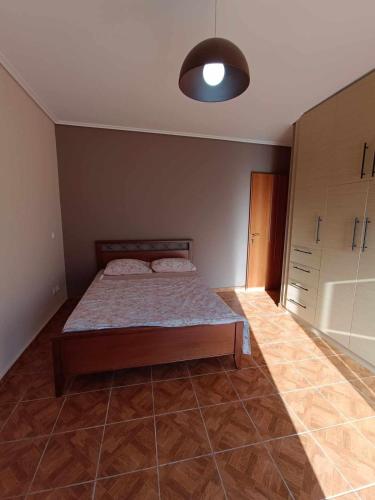 a bedroom with a bed and a light on the ceiling at Komi Luxury Maisonette in Kómi
