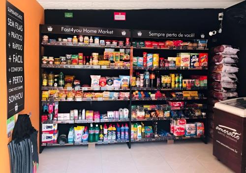 a grocery store aisle with shelves filled with food at Beto Carrero, pé na areia, piscina aquecida, Bali in Piçarras