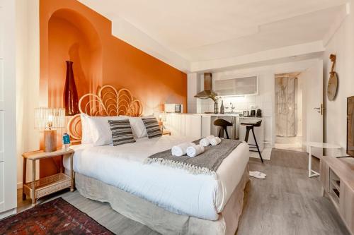 une chambre avec un grand lit et une cuisine dans l'établissement 41#Opéra #GrandsBoulevards #Studio # Paris 02 #AC, à Paris