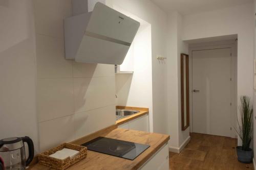 a kitchen with a sink and a counter top at Apartamentos El Aljibe in Badajoz