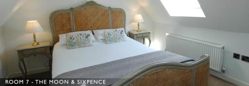 a bedroom with a large white bed with two lamps at The Marine Hotel & Restaurant in Whitby
