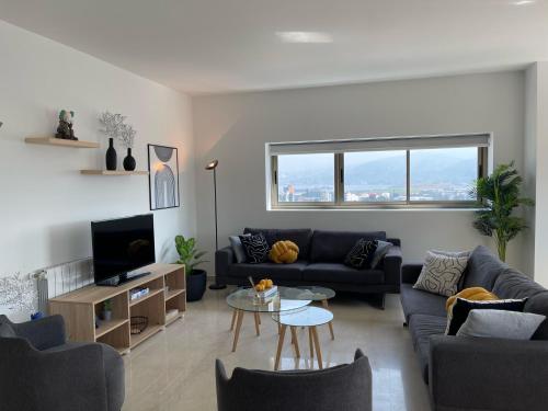 a living room with a couch and a table at 2 Bedroom Apartment AYA tower Mar Mikhael - Beirut in Beirut