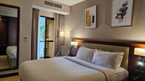 a bedroom with a large bed with white pillows at Imperial Plaza Hotel, Juba in Juba