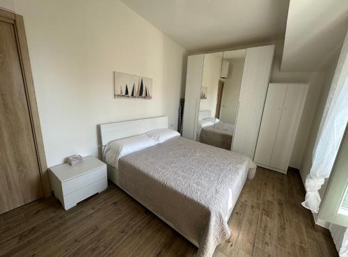a small bedroom with a bed and a mirror at FronteMare in Ladispoli