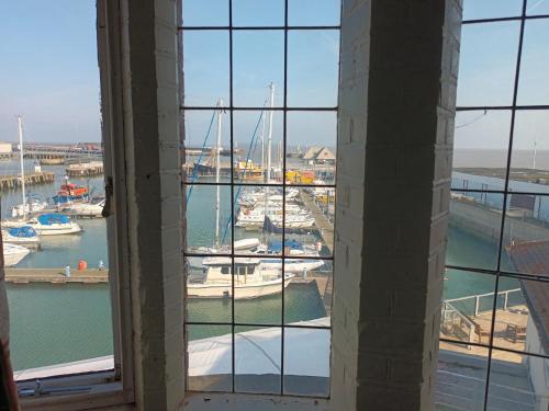 a view of a marina from a window at Royal Norfolk & Suffolk Yacht Club in Lowestoft