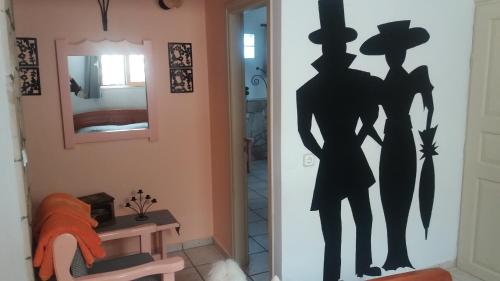 a wall with a silhouette of a man and a woman at Eleni Studios in Agios Nikolaos