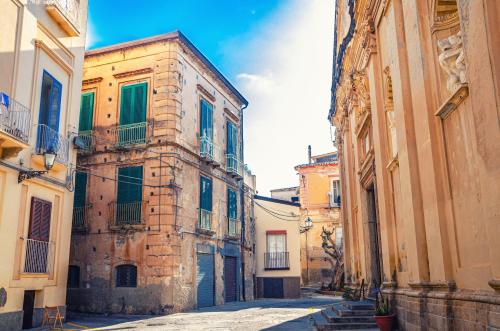 an alley in an old town with buildings at Suite Duomo Tropea in Tropea
