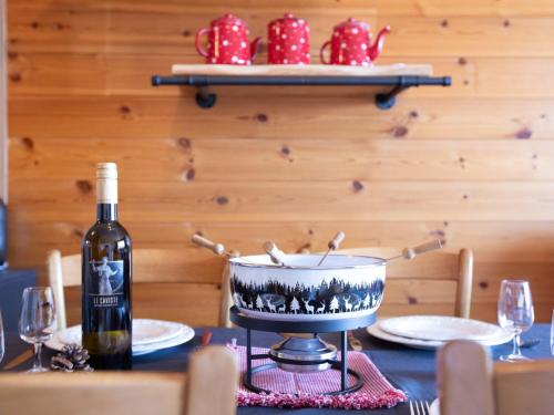 a bottle of wine sitting on top of a table at Apartment Villars Vacances 20 by Interhome in Villars-sur-Ollon