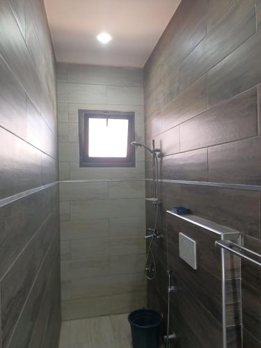 a bathroom with a shower and a window at Keur Dior Diagne in Thiès