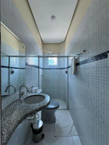 a bathroom with a sink and a toilet at Comodoro Hotel e Churrascaria in Floriano