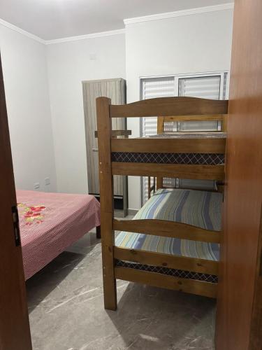 a couple of bunk beds in a room at Casa Raio de Luz in Itanhaém