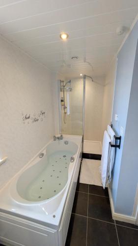 a bathroom with a large tub and a shower at Willowdale B&B in Breakish