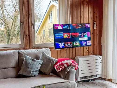 a living room with a couch and a tv at Holiday Home Ixi by Interhome in Extertal