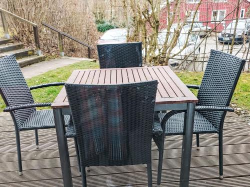a wooden table and chairs on a deck at Holiday Home Ixi by Interhome in Extertal