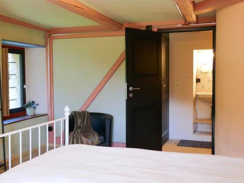 a bedroom with a bed and a black door at Holiday Home Casa Jolli by Interhome in Semione