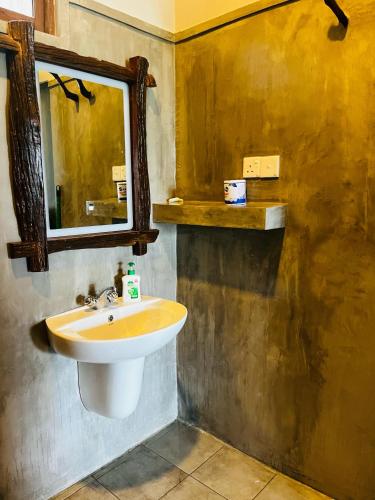 a bathroom with a sink and a mirror at GAIA ELLA Ecolodge and Yoga Centre in Ella
