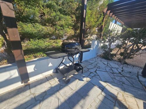a barbecue grill sitting on a stone patio at Kallisti Beach & Spa Villa - A Luxury Seaside Retreat in Lachi