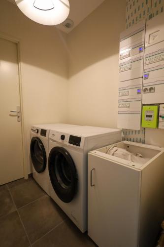 un lave-linge et un lave-linge dans une buanderie dans l'établissement Le Montréal proche CNPE Parking Calme Wifi, à Vaux-en-Bugey
