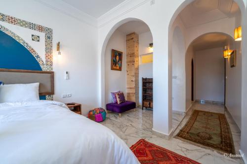 a bedroom with a king sized bed and a hallway at Casa maravillosa in Chefchaouene