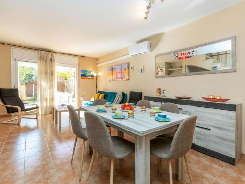 a dining room and living room with a table and chairs at Holiday Home Boters-2 by Interhome in Torredembarra