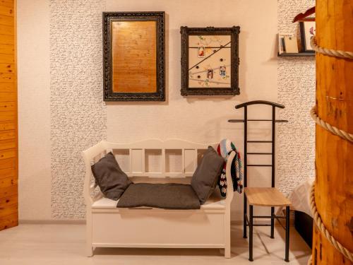a room with a white couch and a clock on the wall at Chalet Srub Pohodář by Interhome in Benešov nad Černou