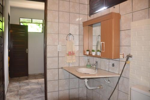a bathroom with a sink and a mirror at Espaço Jardim Secreto Hospedaria in João Pessoa