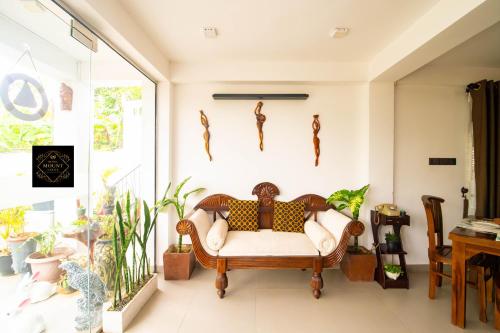 a living room with a couch and some plants at Hotel Mount Castle in Hatton