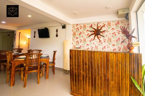 a dining room with a table and a spider on the wall at Hotel Mount Castle in Hatton