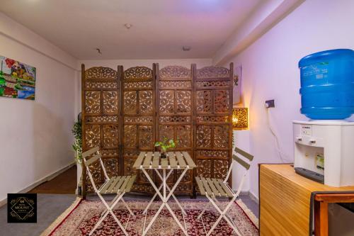 a room with a table and chairs in front of a gate at Hotel Mount Castle in Hatton
