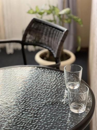two glasses sitting on a table with a chair at Sava Dream in Zhytomyr