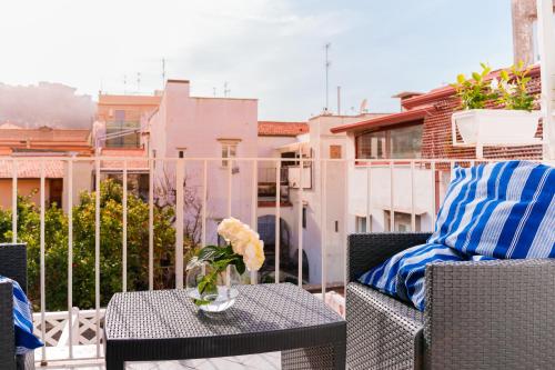 a patio table with a vase of flowers on a balcony at Palazzo Gargiulo Luxury Rooms & Suites in Sorrento