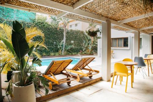 a patio with chairs and a swimming pool at Joli Guesthouse in Maputo