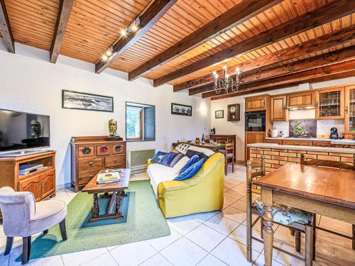 un salon avec un canapé jaune et une cuisine dans l'établissement Holiday Home Maison de Kerguen by Interhome, à Ploemeur