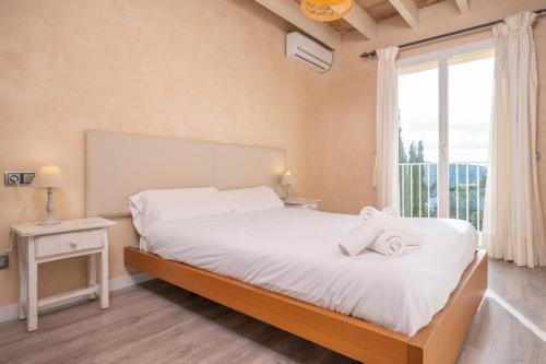 a bedroom with a bed with two towels on it at Porto Luz in Sóller