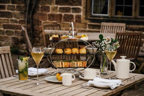 a table with a tray of food and glasses of wine at The Peacock at Rowsley in Great Rowsley