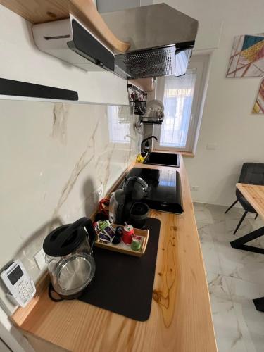 a kitchen with a counter with a sink and a stove at RoomSovama in Pescara